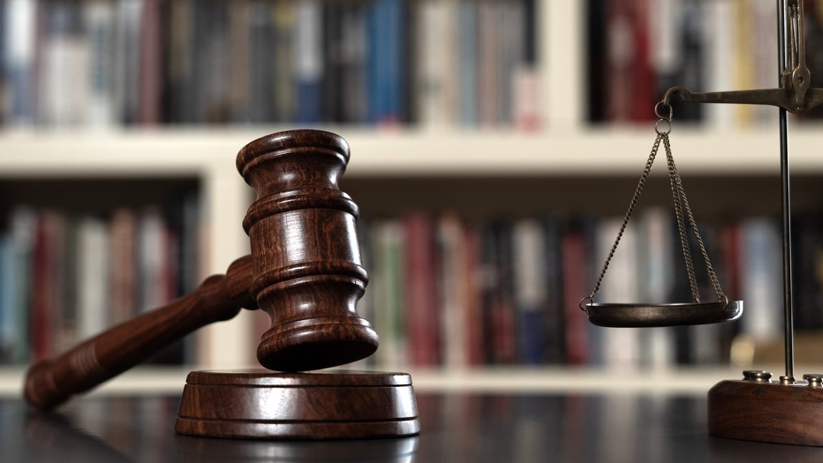 Legal reference library with law books and symbolic objects of justice