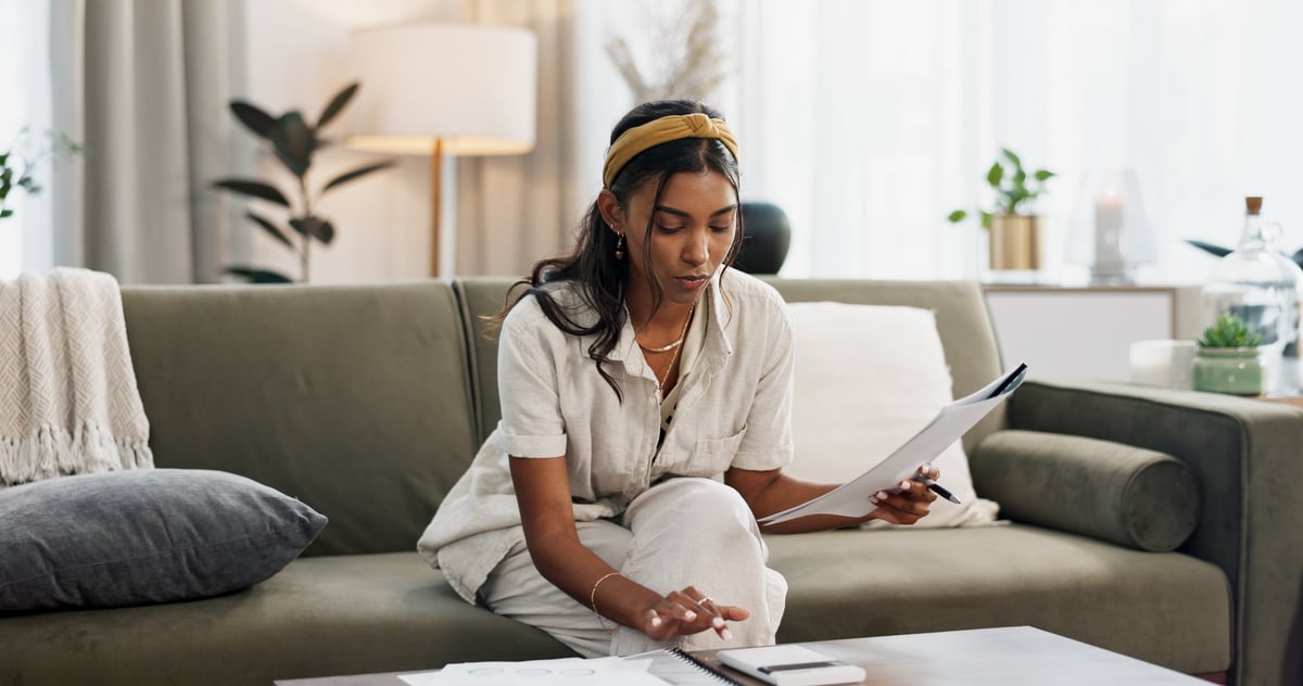 Homeowner reviewing financial documents and budget — finding relief through financial assistance programs