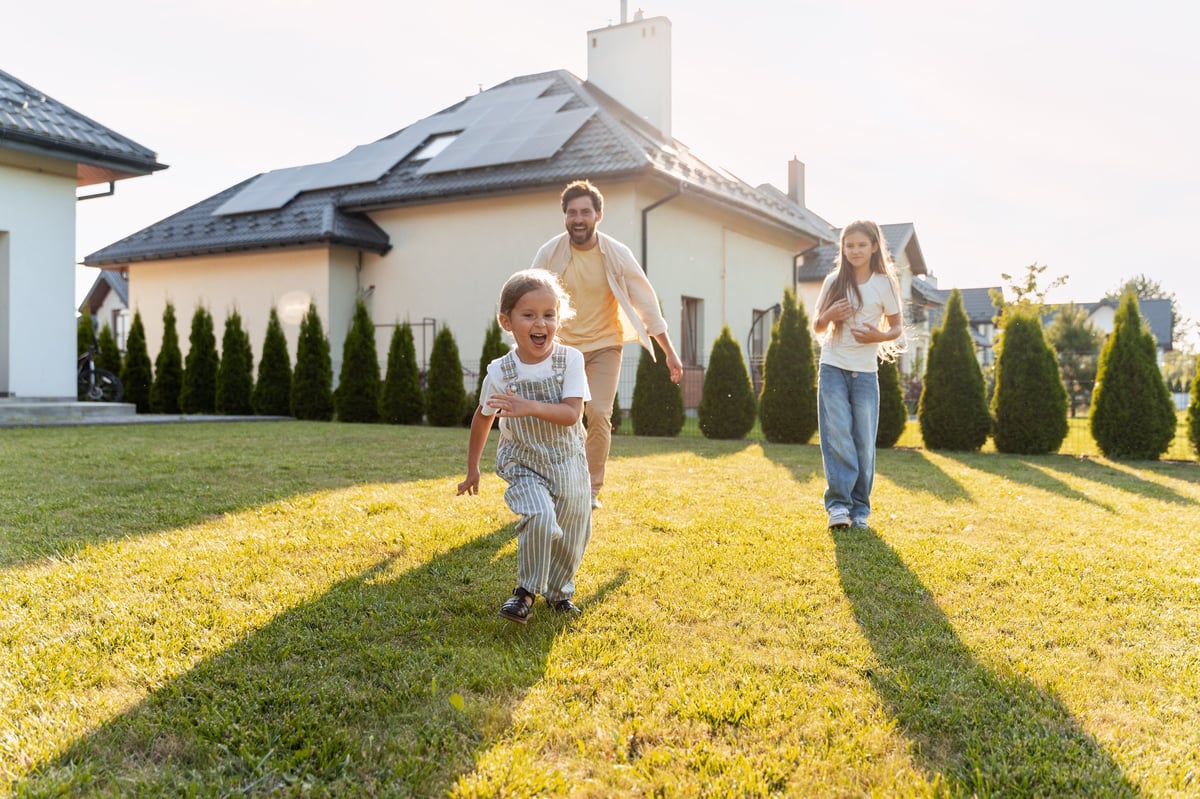 Father and children enjoying their front yard — protecting homeownership