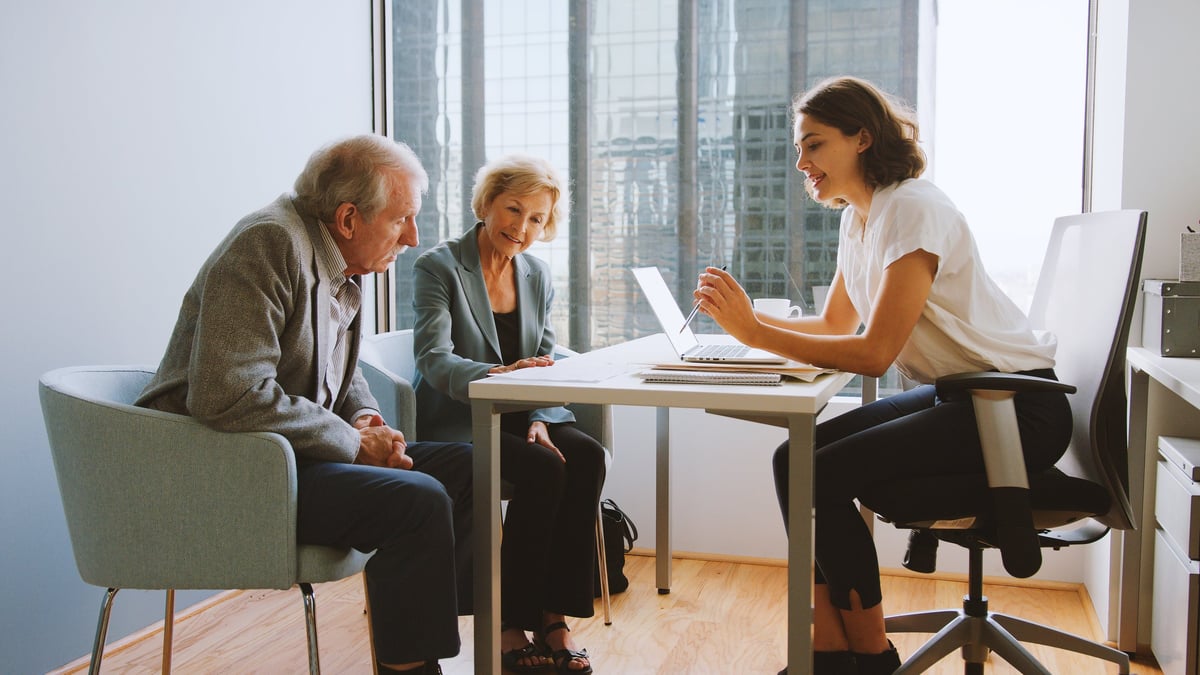 Professional financial advisor meeting with couple — get your foreclosure questions answered