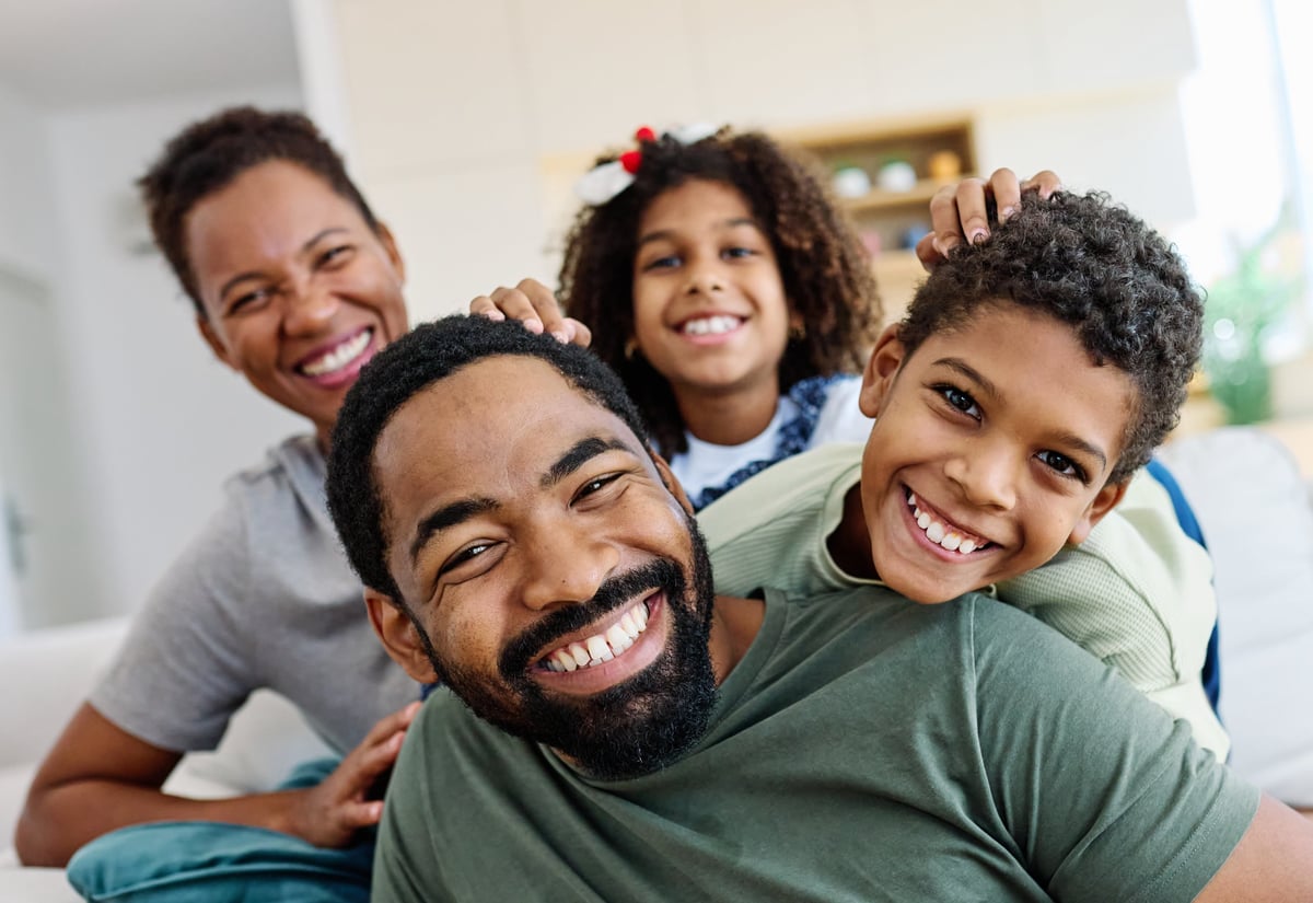 Happy family at home together — homeowners we help protect across all 50 states