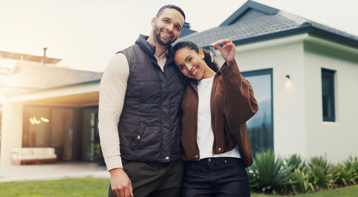 Happy couple with house keys — a fresh start after bankruptcy protection